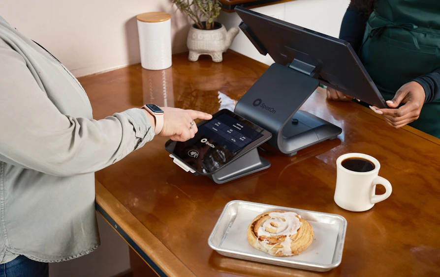 Guest paying by contactless card at a tasting room counter